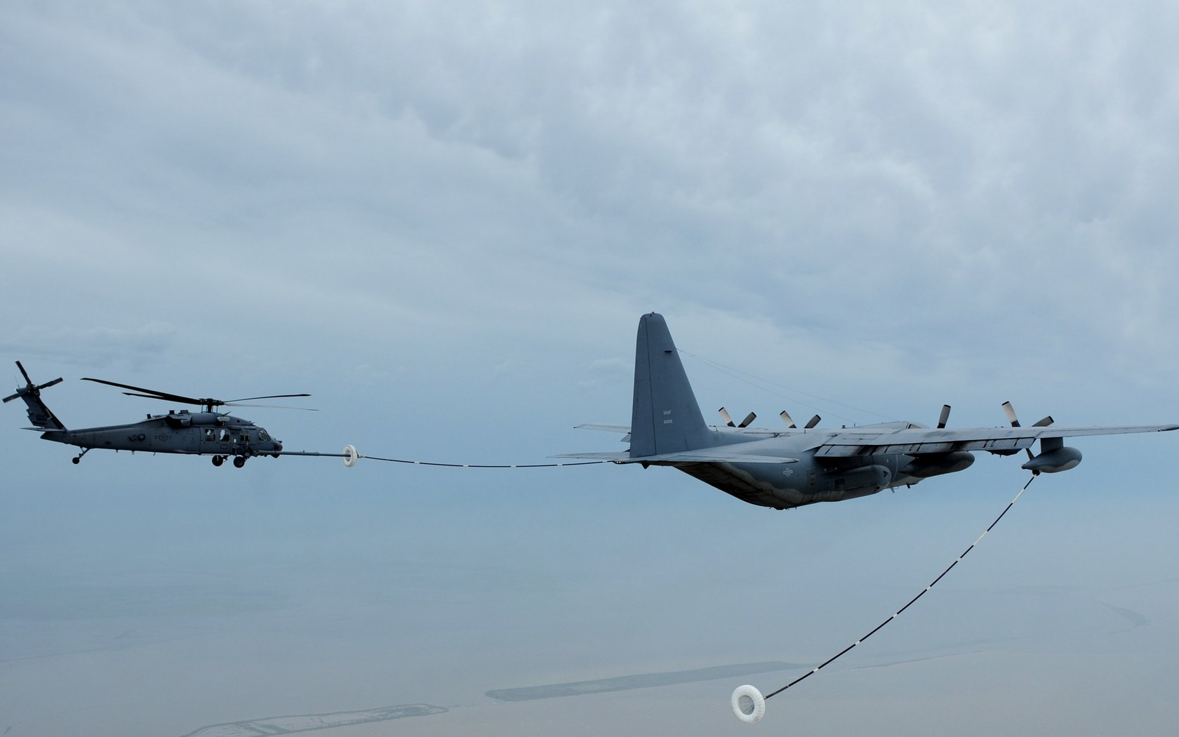 Download High quality HH-60 Pave Hawk receives fuel from a HC-130 Hercules Military Airplanes wallpaper / 1680x1050